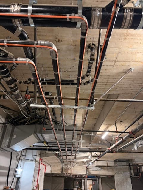Heat trace installed along mechanical piping in a building service area.